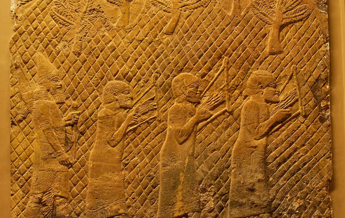 Neo-Assyrian palace relief showing three western prisoners playing lyres, about 700–692 BCE